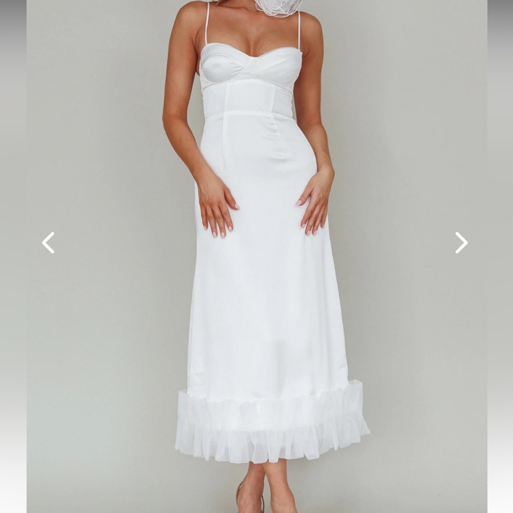 Stunning white dress with ruffled bottom.